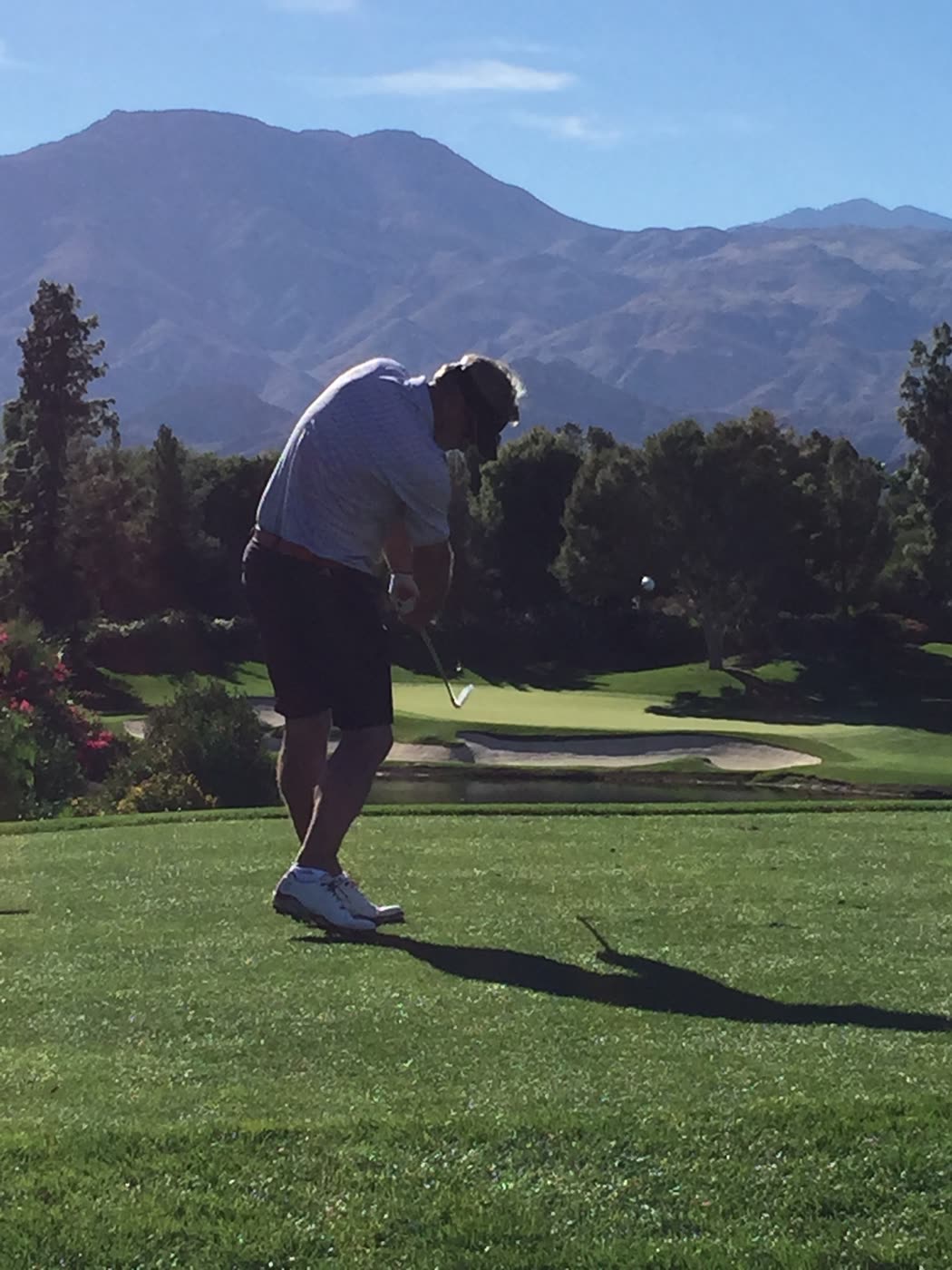 Paul mid-swing with the mountains behind